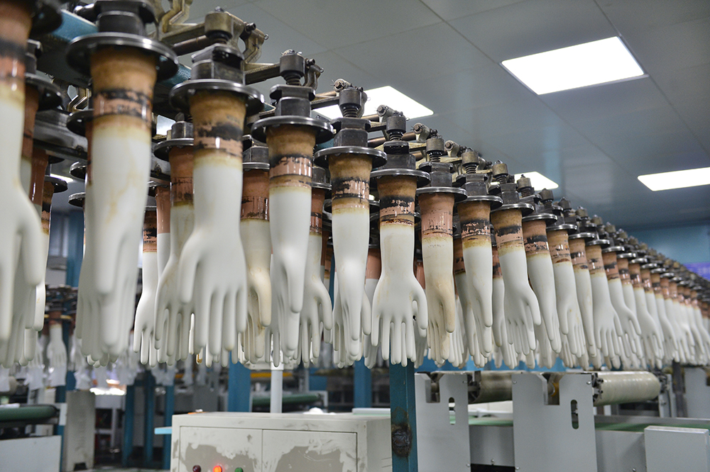 Hand formers at a disposable glove factory wait between uses.